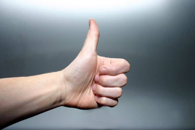 a hand with thumbs up signal